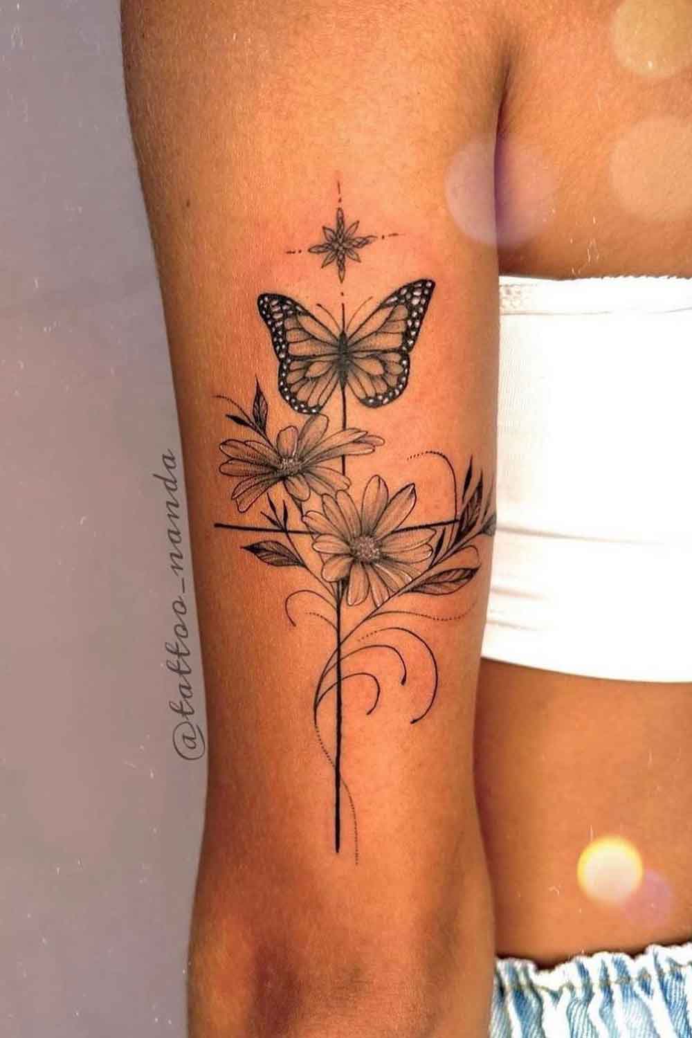tatuagem-de-borboleta-e-cruz-no-braco 